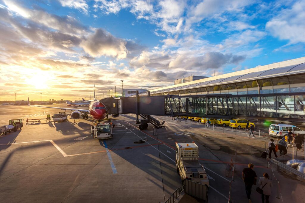 Photo of busy airport tarmac with plane being loaded. Caption: Scoring cheap flights isn’t luck—it’s strategy. And no, it has nothing to do with Tuesdays.