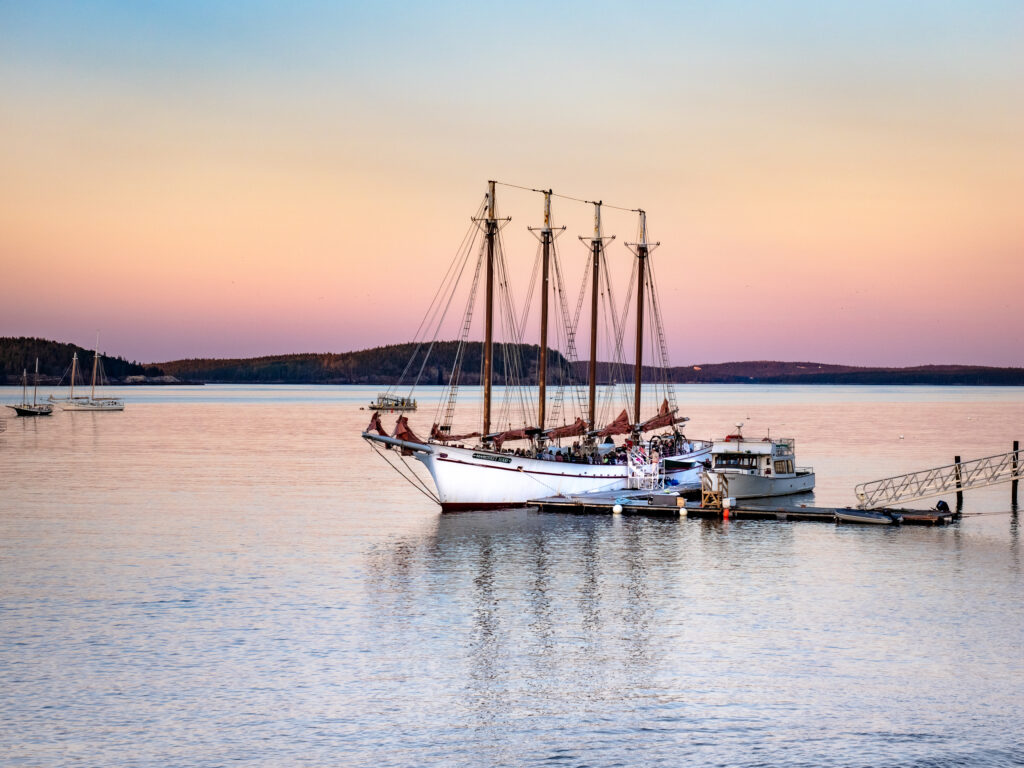 The schooler Margaret Todd in the Mount Desert Narrows off the coast of Bar Harbor, Maine, during a beautiful colorful sunset.